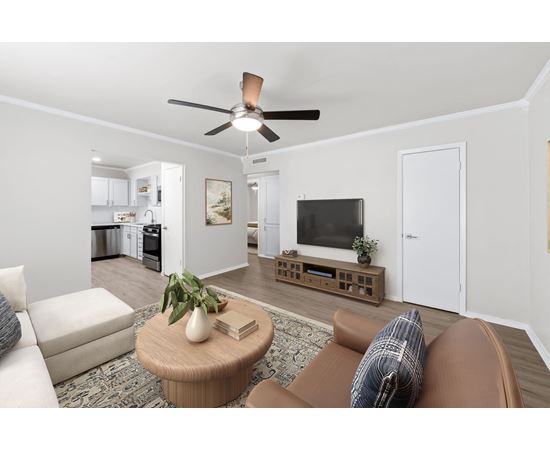 a living room with a ceiling fan and a coffee table in the middle of the room at Sunset Heights, Texas, 78209